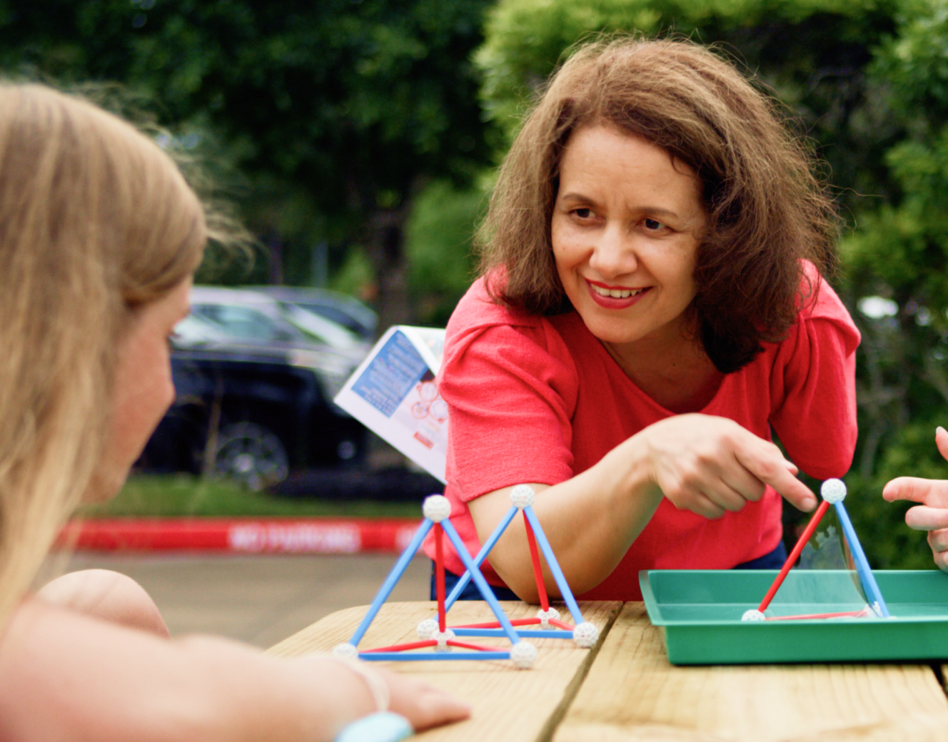 Woman teaching child.